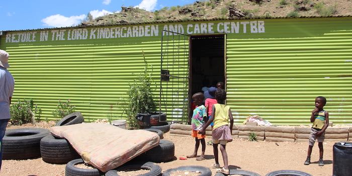 Green corrugated iron classroom named: Rejoice in the Lord kindergarten and care centre.